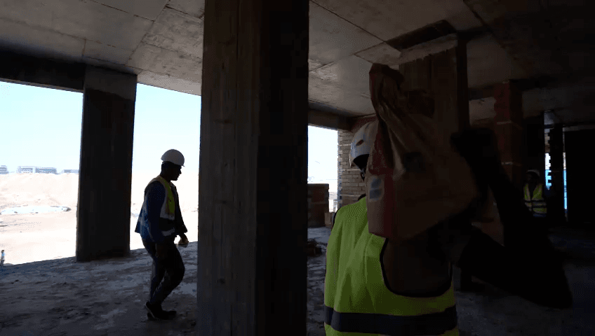 Construction-site activity from the AMAC corporate film.
